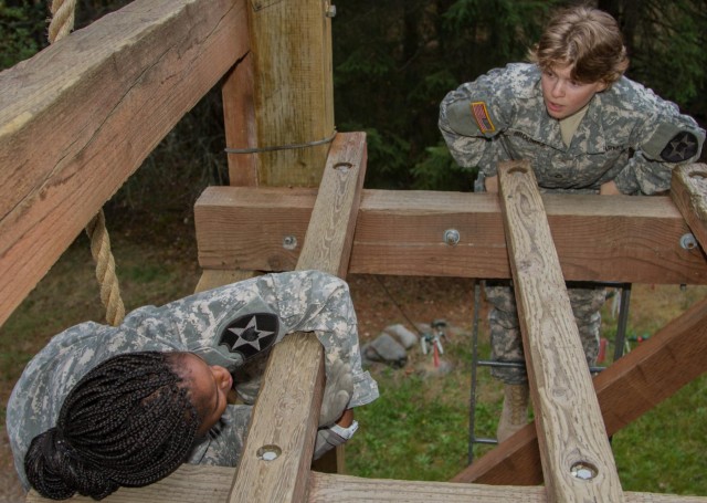 Soldier helps teammate overcome obstacle