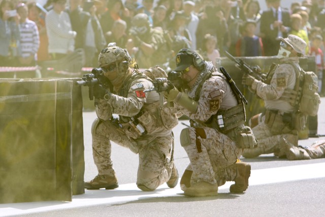 Republic of Korea and U.S. Special Forces Soldiers conduct a hostage rescue demonstration in the main avenue at the at the 2014 RoK Ground Forces Festival, Gyeryong Korea Oct. 2, 2014