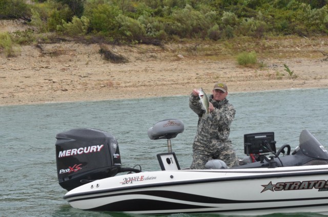 A fisherman in the 9th Annual Fishing for Freedom shows off his catch