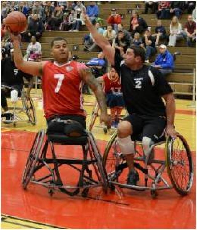 Staff Sgt. Brian Boone blocks a shot in the Army-Marine Corps wheelchair basketball final