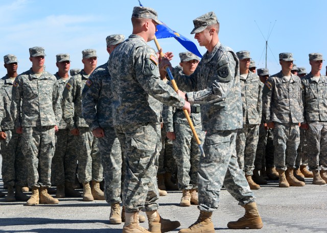 Lt. Col. William Garber hands guidon to Capt. Jesse DeJaynes