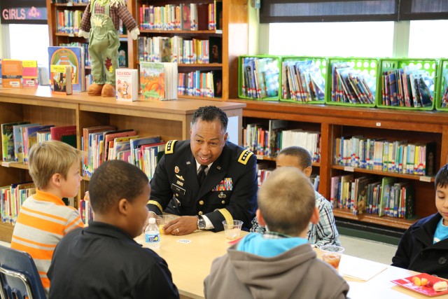 Via speaks with students at Carver Elementary
