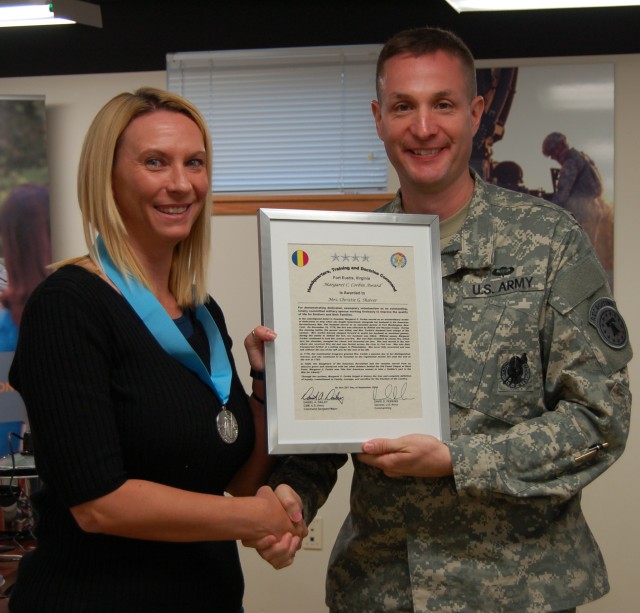 Mrs. Christie Shaver receiving the Margaret C. Corbin Award from 3rd Recruiting Brigade Commander Col. Michael McTigue in an award ceremony at brigade headquarters