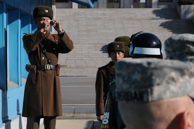 A North Korean Soldier takes a picture of the U.S. Undersecretary of the Army