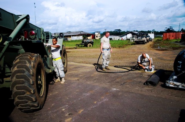 U.S. troops fuel 10-ton forklift at Roberts International Airport in Liberia.