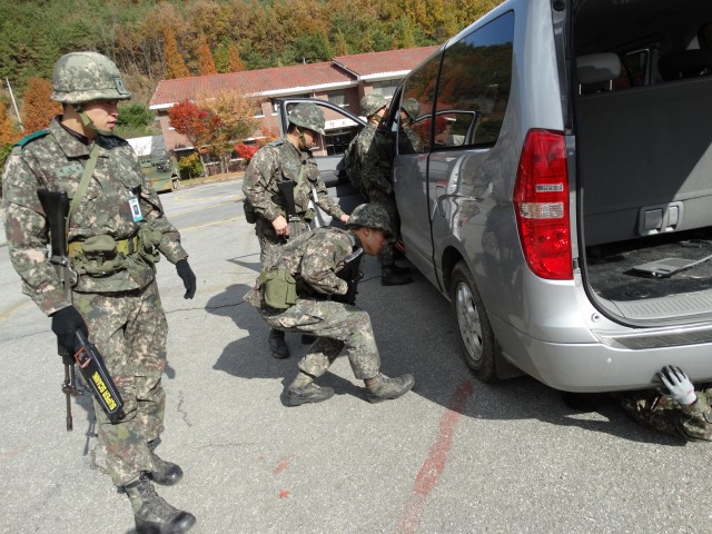 Soldiers conduct a vehicle search