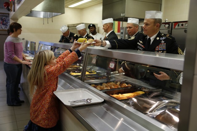 Senior Leaders serve family members a Thanksgiving Meal