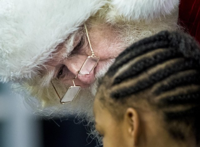 Military service members salute Gold Star children aboard the Snowball Express