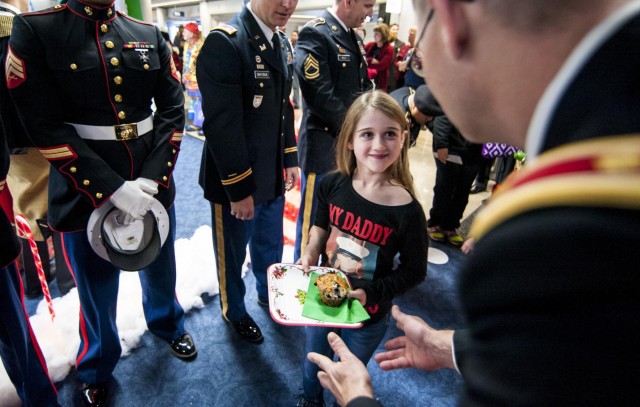 Military service members salute Gold Star children aboard the Snowball Express