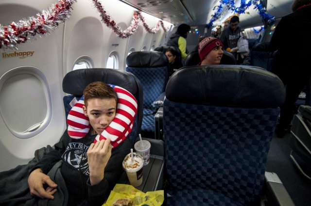 Military service members salute Gold Star children aboard the Snowball Express