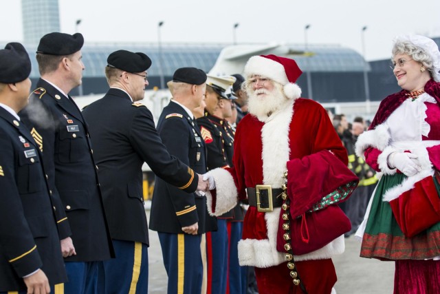 Military service members salute Gold Star children aboard the Snowball Express