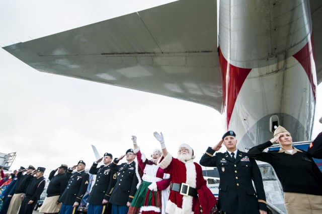 Military service members salute Gold Star children aboard the Snowball Express