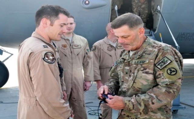 Brig. Gen. Donnie Walker Jr., commanding general of the 3rd Sustainment Command (Expeditionary) recognizes Capt. Nick Burke, flight commander with 17th Airlift Squadron