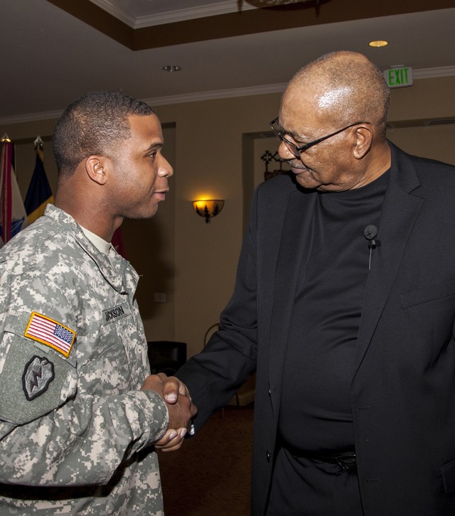 Sgt. 1st Class Christopher Jackson meets John Winkfield, director of the National Training Center Equal Employment Opportunity office