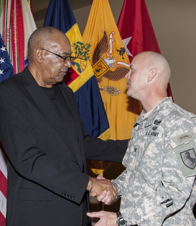 John Winkfield, director of the National Training Center Equal Employment Opportunity office, shakes hands with Col. Kevin Jacobi, 11th ACR