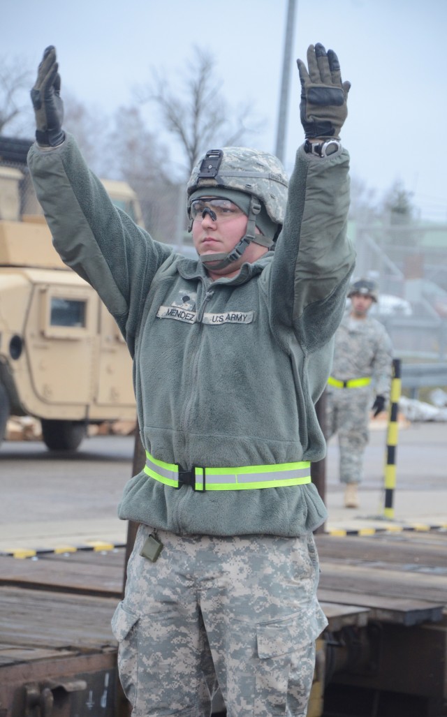 Cutline: Spc. Myles Mendez, a PATRIOT launching station enhanced operator with 5th Battalion, 7th Air Defense Artillery Regiment, 10th Army Air & Missile Defense Command, uses hand and arm signals to 