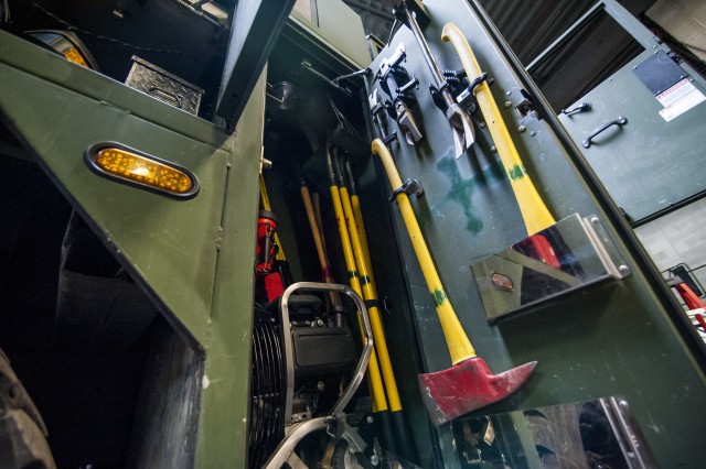 Opening the hose on Army fire truck maintenance