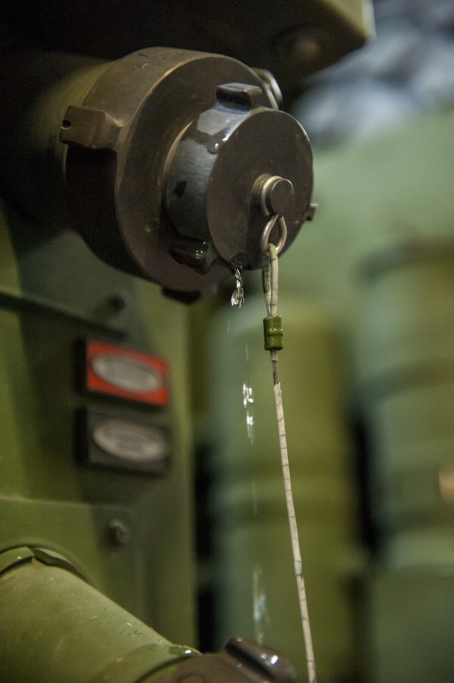 Opening the hose on Army fire truck maintenance