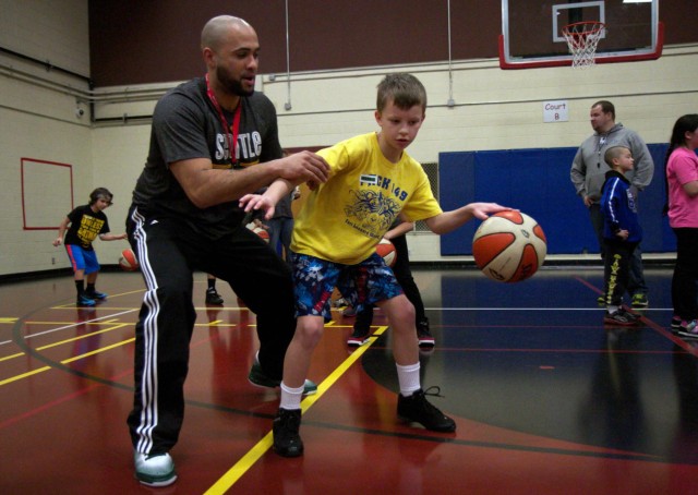 Sue Bird gets hands-on with military children in free basketball clinic