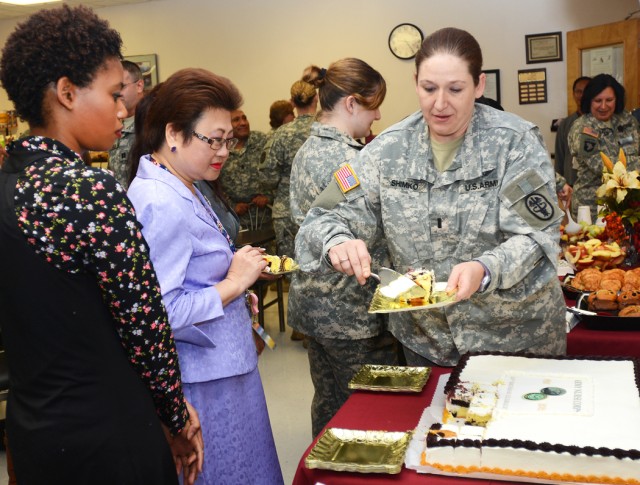 First Lt. Michele Shimko, a registered nurse with Post Anesthesia Care Unit of MEDDAC here, serves cake 