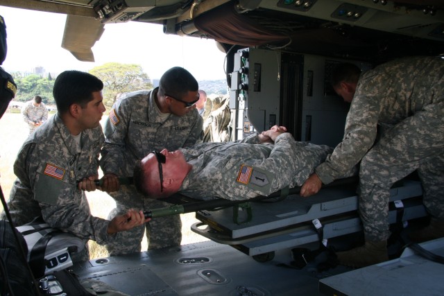 Spc. Delgadillo and Pfc. Henderson load a patient