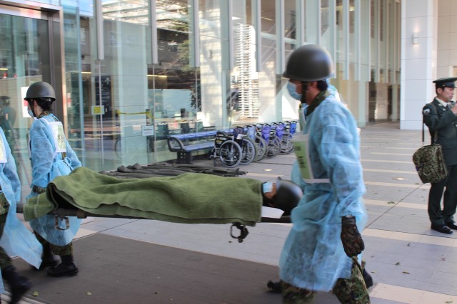 First repsonders transport patient into the triage area