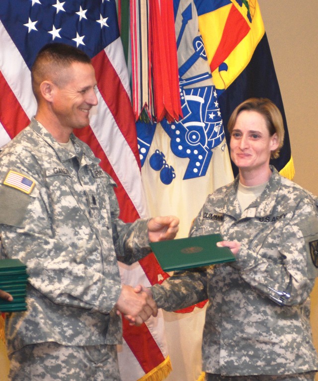 CSM James Gandy congratulates Staff Sgt. Jennifer Cummings