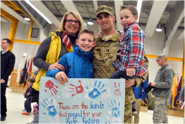 Family members pose with their newly arrived Soldier