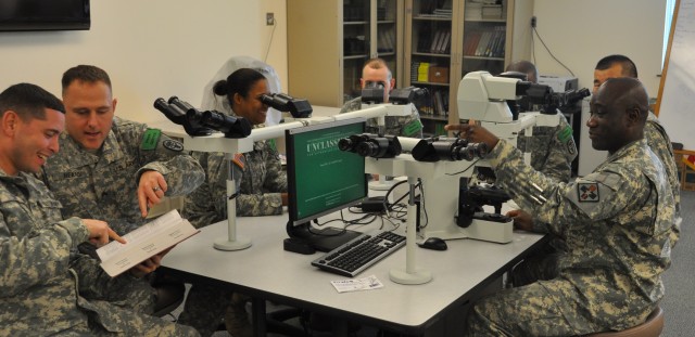 Staff Sgt. Kevin Atiase instructs student in cytotechnology