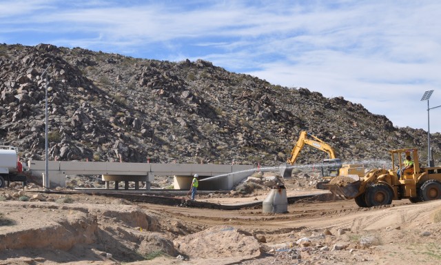 Contractors clear debris from flood channels surrounding Fort Irwin's cantonment area