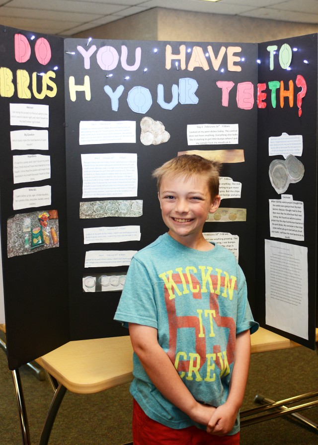 Zachary Cook, 10 and a fourth grader with Mikaela Kopper's class, stands in front of his science experiment