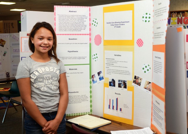 Caley Grace Cordero, 10 and fifth grade student in Edith Holdsworth's class, stands next to her science project titled,