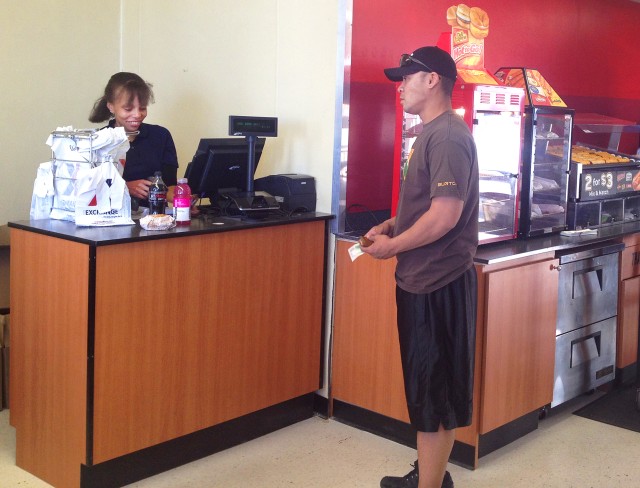 Brittany Jefferson, an Exchange store associate here, works the register as Staff Sgt. Eric Fonoti, with the 11th Armored Cavalry Regiment, approaches the counter