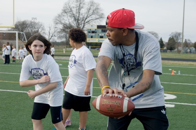 Volunteers support football camp