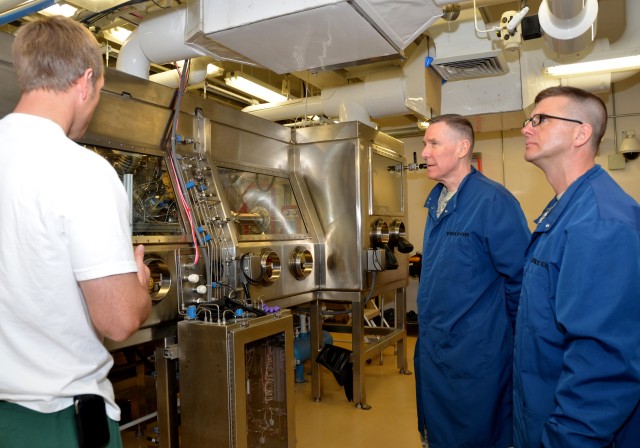 Chaplain (Maj.) Bernard Cornell, Dugway Proving Ground and Chaplain (Col.) Mark A. Penfold, Army Test and Evaluation Command view the Contained Aerosol Chamber March 19 at the Life Sciences complex, D