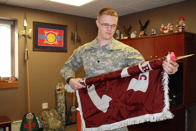 Spc. Jared Seaman prepares to case the MEDDAC colors