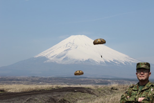 Paratroopers land with Mt. Fuji in the background