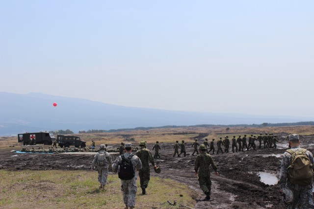 JGSDF Soldiers march off the drop zone after Airborne Operations