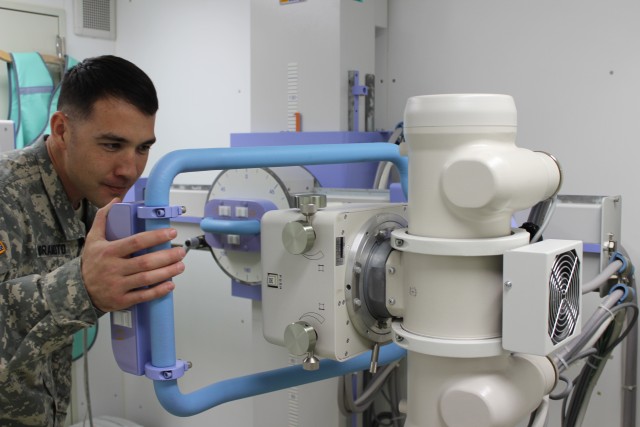 Staff Sgt. Muramoto inspects a X-ray Machine