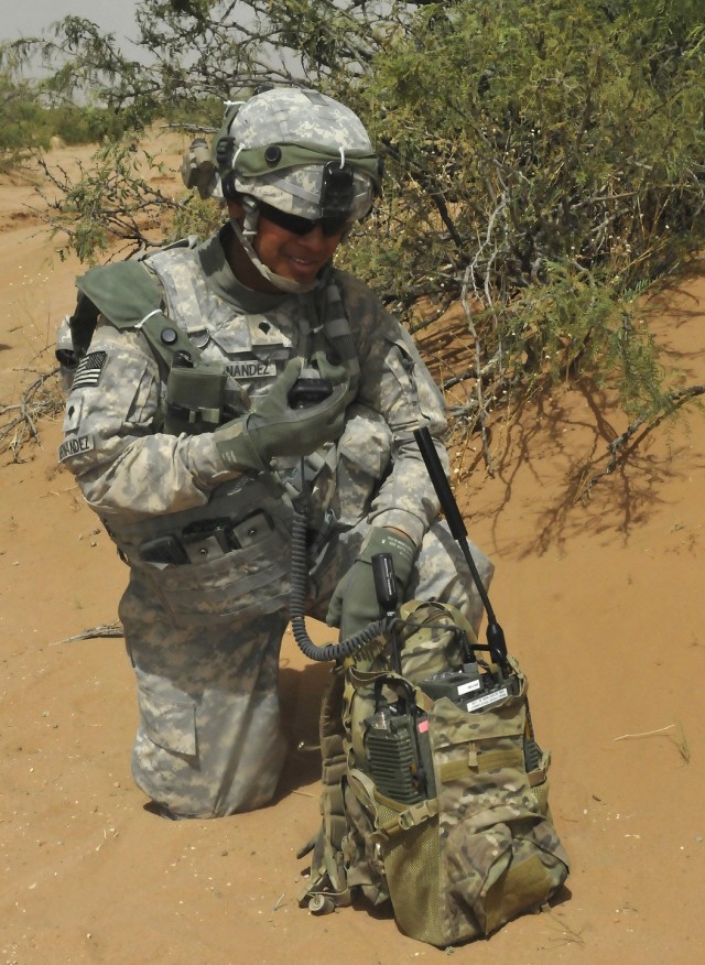 Spc. Sergio Hernandez, 2nd Brigade, 1st Armored Division, conducts a radio check on a Manpack Radio during a Network Integration Evaluation exercise.