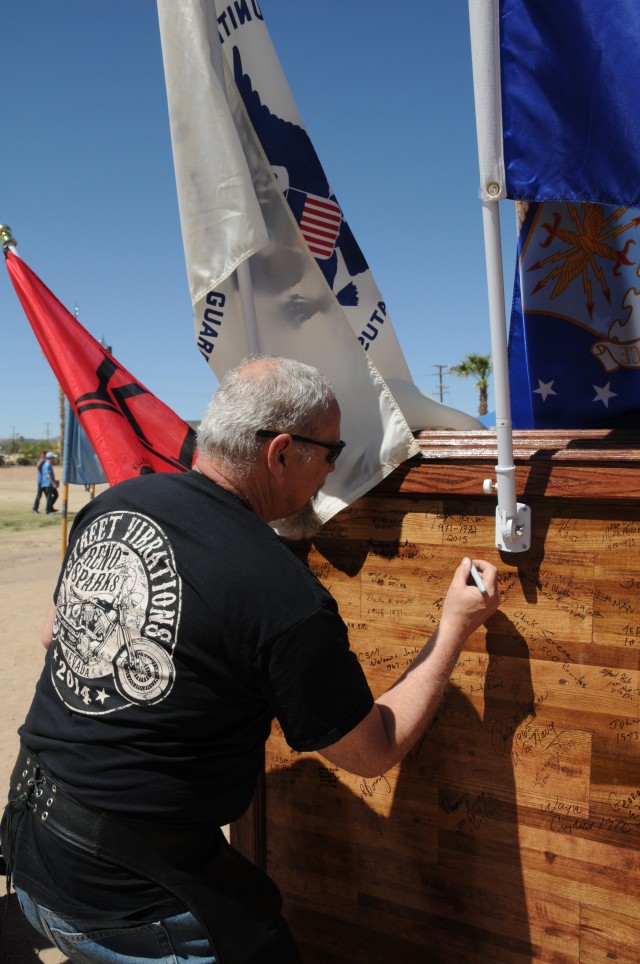 Joseph J. LaTour, a Vietnam War Veteran who served with the U.S. Navy, signs his name