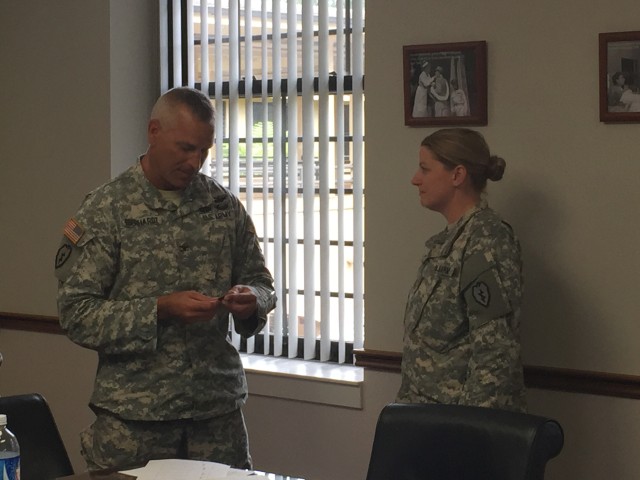 Col. Eberhardt presents Maj. Giorio a coin for patient safety