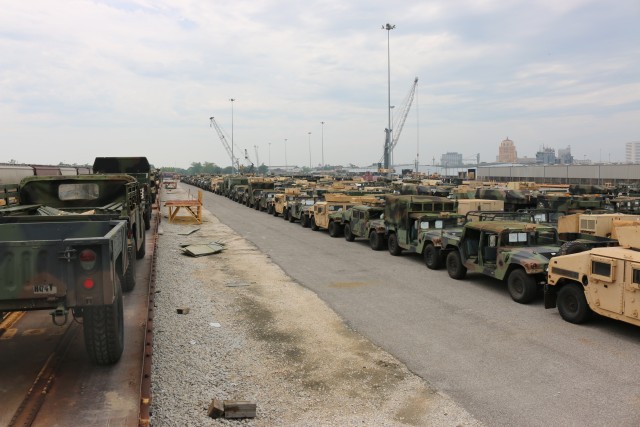 25th ID vehicles make their way from storage yard onto rail.