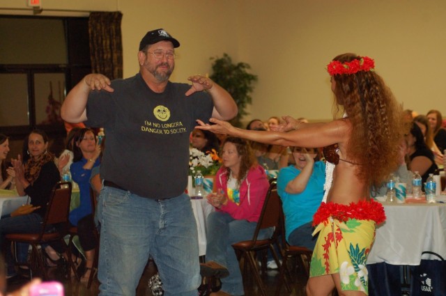 Male spouse dances at a military spouse appreciation event