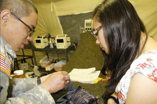 Showing his Daughter an Intravenous Catheter