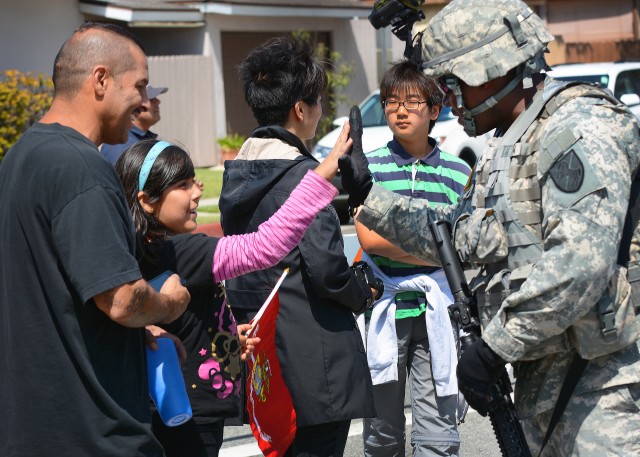 Staff Sgt. Byron Robinson high-fives Sade Rosas