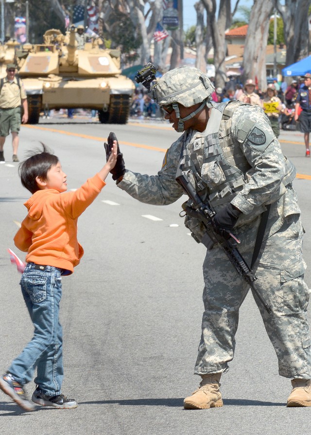 Darren Ko, 6, high-fives Staff Sgt. Robinson Byron