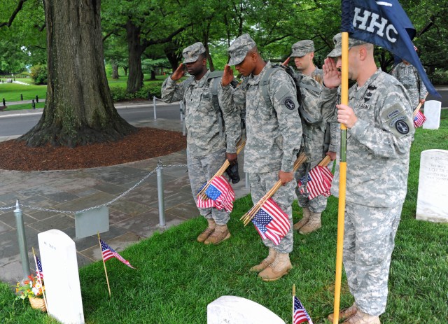 Soldiers participate during Flags In at Arlington Cemetery