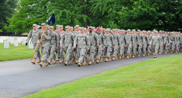 Soldiers participate during Flags In at Arlington Cemetery