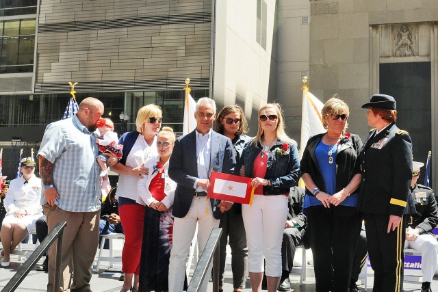 Gold Star Family receives a gold star flag during Chicago Memorial Day commemoration